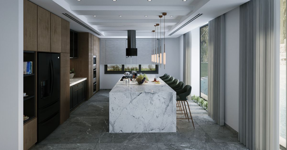 Detalle de cocina con isla de mármol y herrajes metálicos oscuros